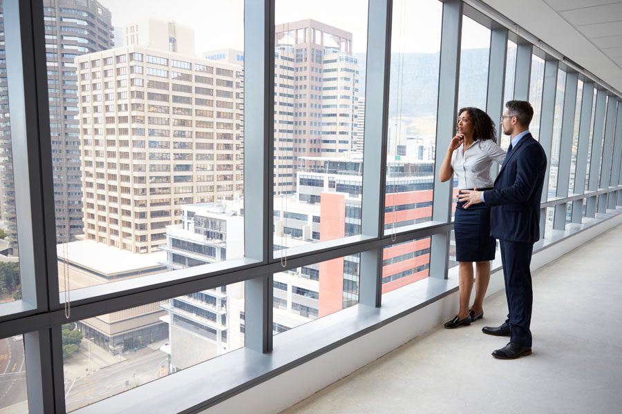 Business Insurance - Real Estate Investors Looking Out the Window Pondering the Next Deal